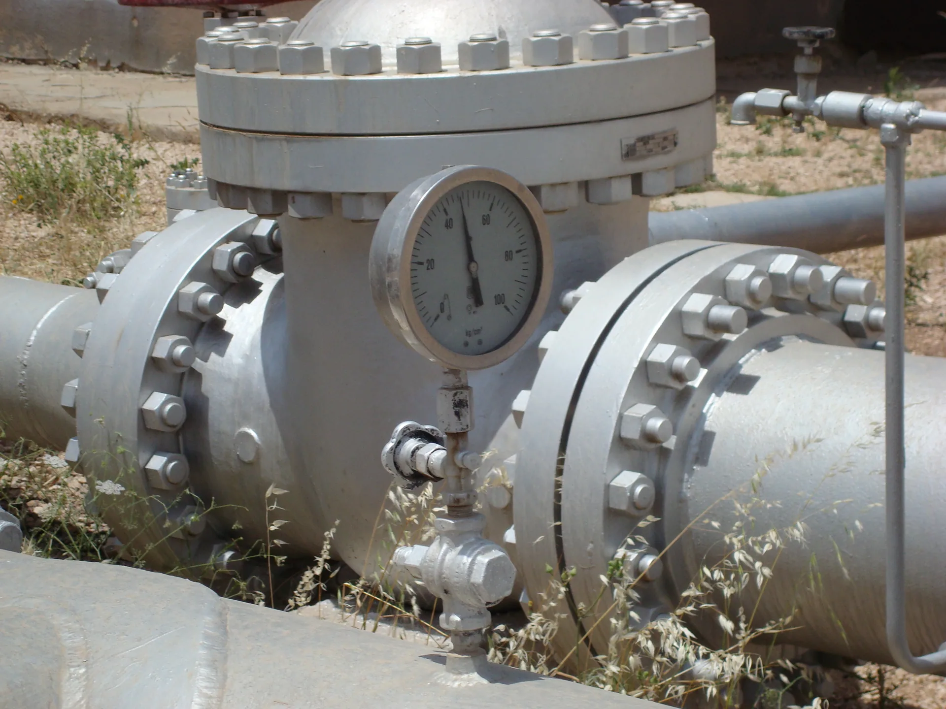 Flanged gate valve and pressure gauge on a pumping station pipeline manifold