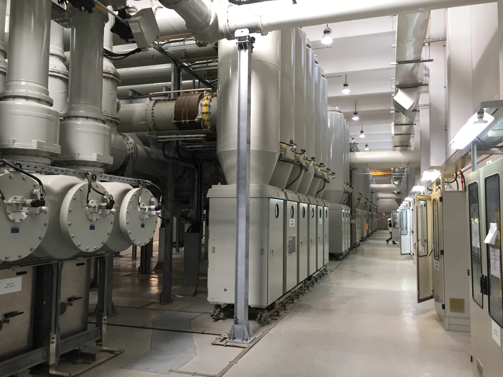GIS switchgear hall with SF6 busbar and control cubicles at an Abu Dhabi substation
