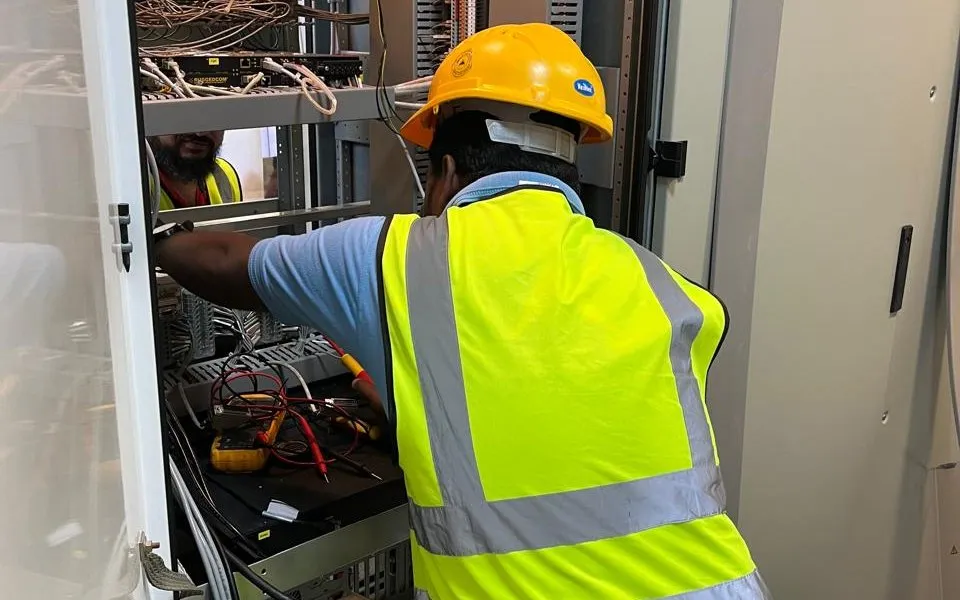 Almafor engineer working on a control panel during the SCMS replacement at Khalifa Port